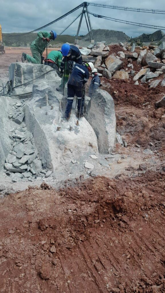 Drilling and pouring of Rock breaking Chemical on massive boulders on a mine. Very challenging formation boulder.