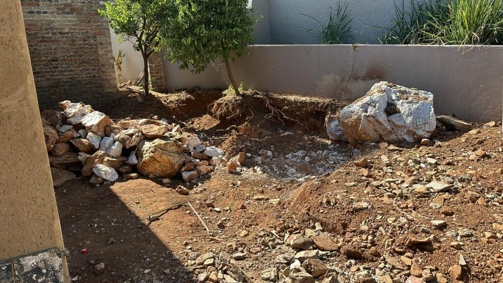 Rubble removal and sensitive rock breaking next to house foundation for installation of pool.