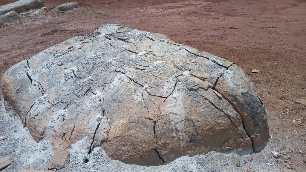 Drilling and pouring of Rock breaking Chemical on massive boulders on a mine.