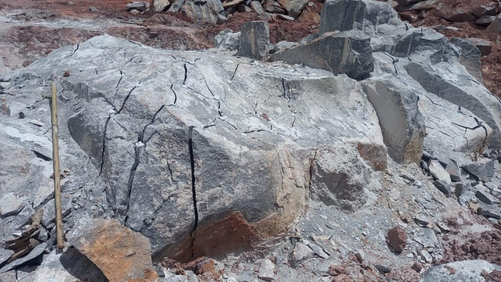 Drilling and pouring of Rock breaking Chemical on massive boulders on a mine.